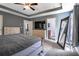 Primary bedroom with tray ceilings, two dressers, and an en-suite bathroom entrance at 108 Spring View Br, Dallas, GA 30157