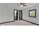 Spacious bedroom with neutral carpet, ceiling fan and two entries to the hallway and bathroom at 391 S Bend Se Ave, Atlanta, GA 30315