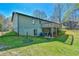 Exterior view of the backyard featuring a tiered deck, patio, and a lawn at 5774 Harbor Dr, Buford, GA 30518