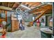 Unfinished basement with exposed ceiling, storage, and stairs to upper level at 5774 Harbor Dr, Buford, GA 30518