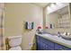 Bathroom featuring blue vanity, tile countertop, and matching blue towels at 5774 Harbor Dr, Buford, GA 30518