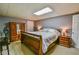 Spacious bedroom with neutral walls, carpet, and a classic wooden bed frame at 5774 Harbor Dr, Buford, GA 30518