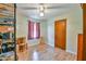 Bright bedroom with wood floors, ceiling fan, window, and an unfinished storage area at 5774 Harbor Dr, Buford, GA 30518