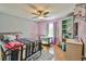 Bright bedroom with a metal frame bed, changing table, and playful decorations at 5774 Harbor Dr, Buford, GA 30518