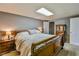 Spacious bedroom with neutral walls, carpet, and a classic wooden bed frame at 5774 Harbor Dr, Buford, GA 30518