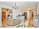 Cozy dining area with wood floors, modern lighting, and seating for four at 5774 Harbor Dr, Buford, GA 30518