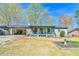 Charming single-story home with a covered front porch and open garage on a sunny day at 5774 Harbor Dr, Buford, GA 30518