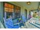Charming front porch with rocking chairs and potted plants, inviting relaxation at 5774 Harbor Dr, Buford, GA 30518