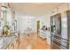 Modern kitchen with white cabinets, stainless steel fridge, and adjacent dining area at 5774 Harbor Dr, Buford, GA 30518
