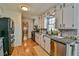Bright kitchen with white cabinets, granite countertops, and stainless steel appliances at 5774 Harbor Dr, Buford, GA 30518