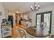 Bright kitchen with white cabinets, stainless steel appliances, and an adjacent dining area at 5774 Harbor Dr, Buford, GA 30518