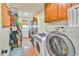 Functional laundry room with washer, dryer, storage shelves, and ample space at 5774 Harbor Dr, Buford, GA 30518