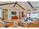Comfortable living room with vaulted ceilings, wood beams, and contemporary furnishings at 5774 Harbor Dr, Buford, GA 30518