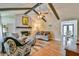 Open living room with vaulted ceilings, a fireplace, and dining area access at 5774 Harbor Dr, Buford, GA 30518