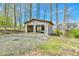 Wood framed, detached outbuilding on a gravel base has space for parking equipment or vehicles at 5774 Harbor Dr, Buford, GA 30518
