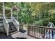 Inviting back deck with stairs leading to a screened porch and a beautiful wooded yard at 2429 Brookgreen Nw Commons, Kennesaw, GA 30144