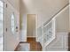 Welcoming entryway featuring hardwood floors, a staircase with white railings, and a charming front door at 2429 Brookgreen Nw Commons, Kennesaw, GA 30144