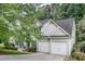 Well-maintained home with a two-car garage, complemented by mature trees and a neatly landscaped yard at 2429 Brookgreen Nw Commons, Kennesaw, GA 30144