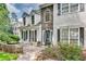 Inviting home featuring stone accents, dormer windows, and a charming front patio with outdoor seating at 2429 Brookgreen Nw Commons, Kennesaw, GA 30144