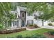 Charming two-story home with stone accents, manicured landscaping, and a welcoming front patio with seating at 2429 Brookgreen Nw Commons, Kennesaw, GA 30144