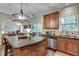 Bright and airy kitchen with an island, stainless appliances, wood cabinetry, and easy access to living room at 2429 Brookgreen Nw Commons, Kennesaw, GA 30144