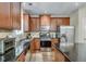 Modern kitchen features stainless steel appliances, granite countertops and wood cabinets for a sleek aesthetic at 2429 Brookgreen Nw Commons, Kennesaw, GA 30144