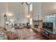 Cozy living room with soaring ceilings, stone fireplace, and large windows providing ample natural light at 2429 Brookgreen Nw Commons, Kennesaw, GA 30144