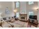 Inviting living area featuring high ceilings, a stone fireplace, and an array of windows for bright, natural light at 2429 Brookgreen Nw Commons, Kennesaw, GA 30144