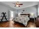 Comfortable main bedroom with hardwood floors, ceiling fan, and an ensuite bathroom, ideal for relaxation at 2429 Brookgreen Nw Commons, Kennesaw, GA 30144