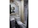 Stylish bathroom featuring marble tile, a decorative mirror, and a shower with a neutral-toned curtain at 3236 Jonesboro Rd, Atlanta, GA 30354