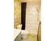 Modern bathroom features a tiled shower, stylish fixtures, and vibrant wallpaper at 3236 Jonesboro Rd, Atlanta, GA 30354