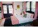 Main bedroom boasts a plush bed, stylish decor, and access to a private outdoor space at 3236 Jonesboro Rd, Atlanta, GA 30354