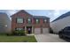 Charming two-story brick home featuring a well-manicured lawn and an attached two-car garage at 3484 Enterkin Ln, Atlanta, GA 30349