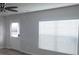 Bright living room featuring a ceiling fan, large window, and a glass door at 3484 Enterkin Ln, Atlanta, GA 30349