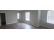 Open concept living room featuring neutral walls and modern wood-look flooring at 3484 Enterkin Ln, Atlanta, GA 30349