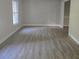 Bedroom with plank flooring, light gray walls and a large window for natural light at 409 Arbor Ridge Dr, Stone Mountain, GA 30087