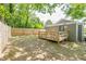 Backyard view featuring wood patio, exterior building, and surrounding greenery at 299 Fletcher Sw St, Atlanta, GA 30315