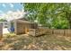 Backyard view featuring wood patio, exterior building, and surrounding greenery at 299 Fletcher Sw St, Atlanta, GA 30315