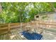 Backyard view featuring wood patio, surrounding greenery, and privacy fence at 299 Fletcher Sw St, Atlanta, GA 30315