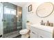 Updated bathroom featuring a tiled shower, modern fixtures, and stylish vanity with a round mirror at 299 Fletcher Sw St, Atlanta, GA 30315