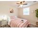 Bright bedroom features ceiling fan, and a cozy bed with stylish striped linens at 299 Fletcher Sw St, Atlanta, GA 30315