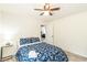 Bright bedroom features a ceiling fan, blue floral bedding, and luxury vinyl plank flooring at 299 Fletcher Sw St, Atlanta, GA 30315