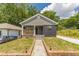 This renovated home features a cozy front porch and a brick walkway, blending classic charm with modern updates at 299 Fletcher Sw St, Atlanta, GA 30315