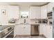 Stylish kitchen featuring white cabinets, stainless appliances, granite counters, and modern design elements at 299 Fletcher Sw St, Atlanta, GA 30315