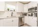 Bright kitchen with white cabinetry, granite countertops, stainless steel appliances, and modern fixtures at 299 Fletcher Sw St, Atlanta, GA 30315