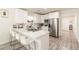 Modern kitchen with white cabinetry, stainless steel appliances, and breakfast bar seating at 299 Fletcher Sw St, Atlanta, GA 30315