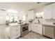 Bright kitchen featuring stainless steel appliances, white cabinets, and an open layout at 299 Fletcher Sw St, Atlanta, GA 30315