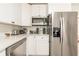 Modern kitchen with white cabinets, stainless steel appliances, and subway tile backsplash at 299 Fletcher Sw St, Atlanta, GA 30315