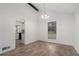 Open dining area with hardwood floors, a modern chandelier, and a view into the adjacent kitchen at 5444 Wylstream, Norcross, GA 30093