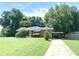 Cozy single-story home with a carport, mature trees, and a well-manicured lawn at 1024 Magnolia Dr, Smyrna, GA 30082
